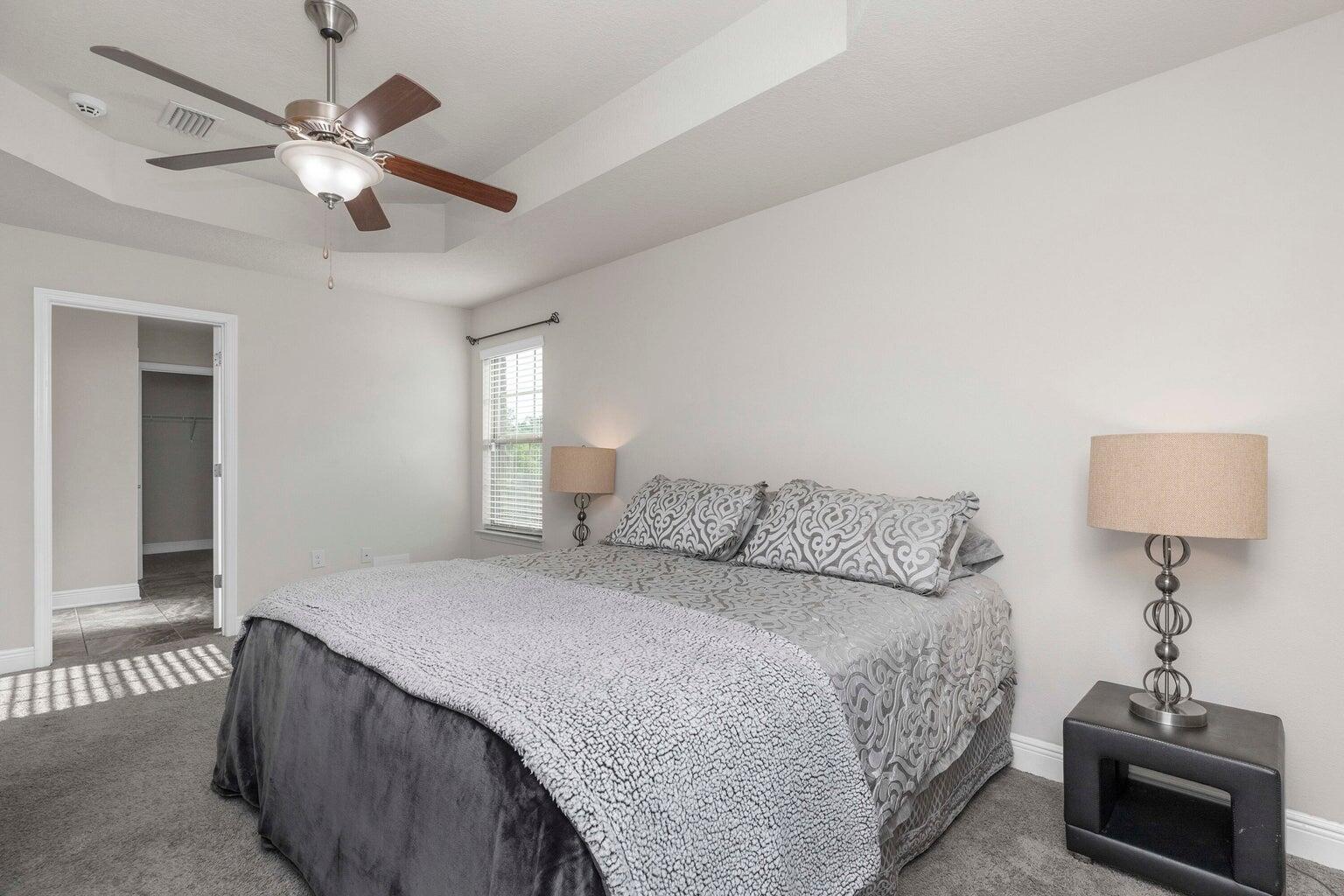 2365 Genevieve Way Crestview, FL 32536 - Photo 19 of 33 a bedroom with a bed and a chandelier