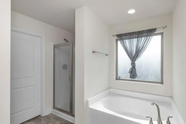 a white bath tub sitting next to a window
