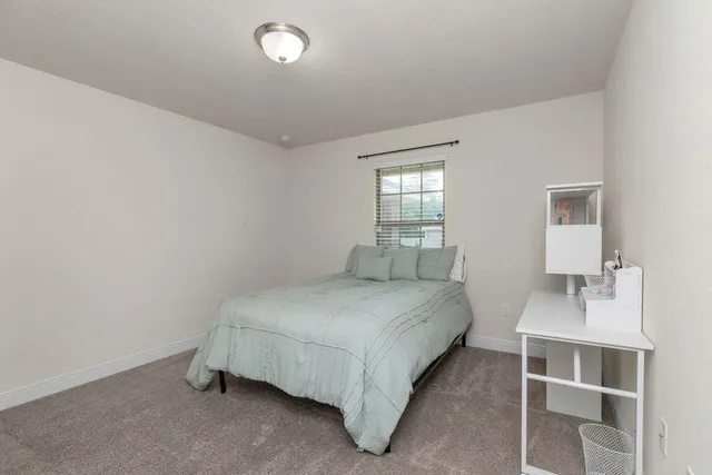 a bedroom with a bed and window