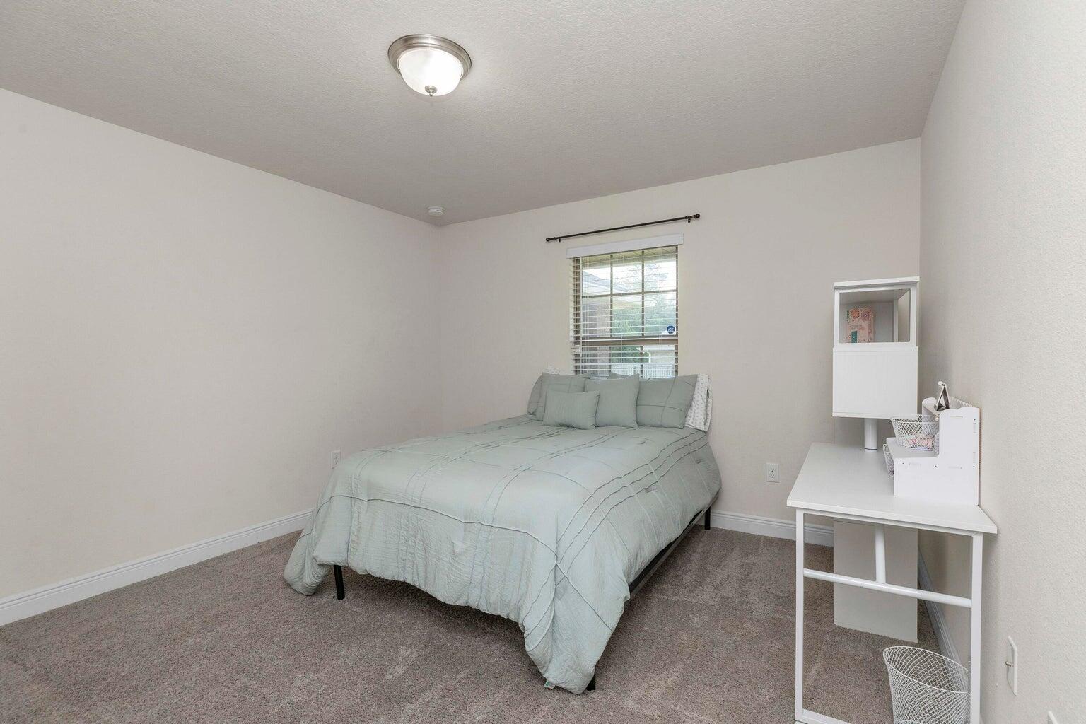 2365 Genevieve Way Crestview, FL 32536 - Photo 25 of 33 a bedroom with a bed and window