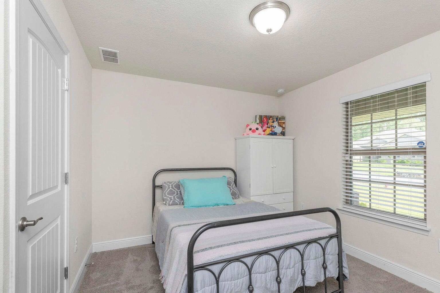 2365 Genevieve Way Crestview, FL 32536 - Photo 28 of 33 a bedroom with a bed and a window