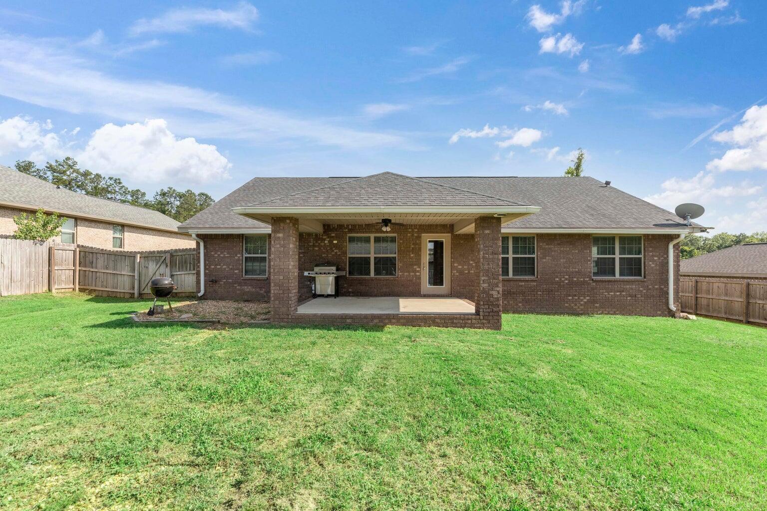 2365 Genevieve Way Crestview, FL 32536 - Photo 4 of 33 a front view of a house with a garden and porch
