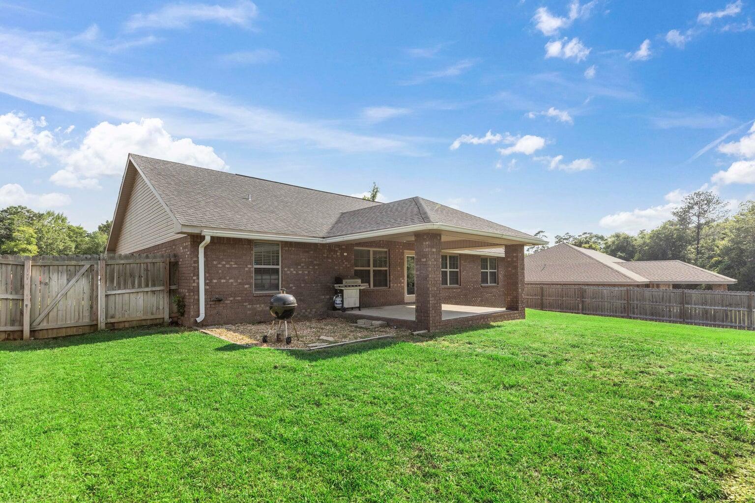 2365 Genevieve Way Crestview, FL 32536 - Photo 5 of 33 a front view of a house with patio and garden