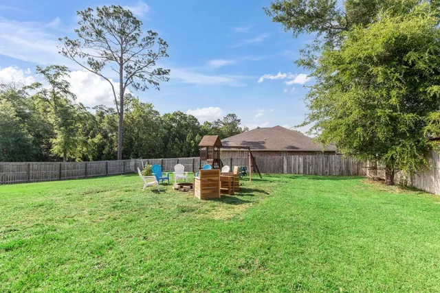 a backyard of a house with table and chairs