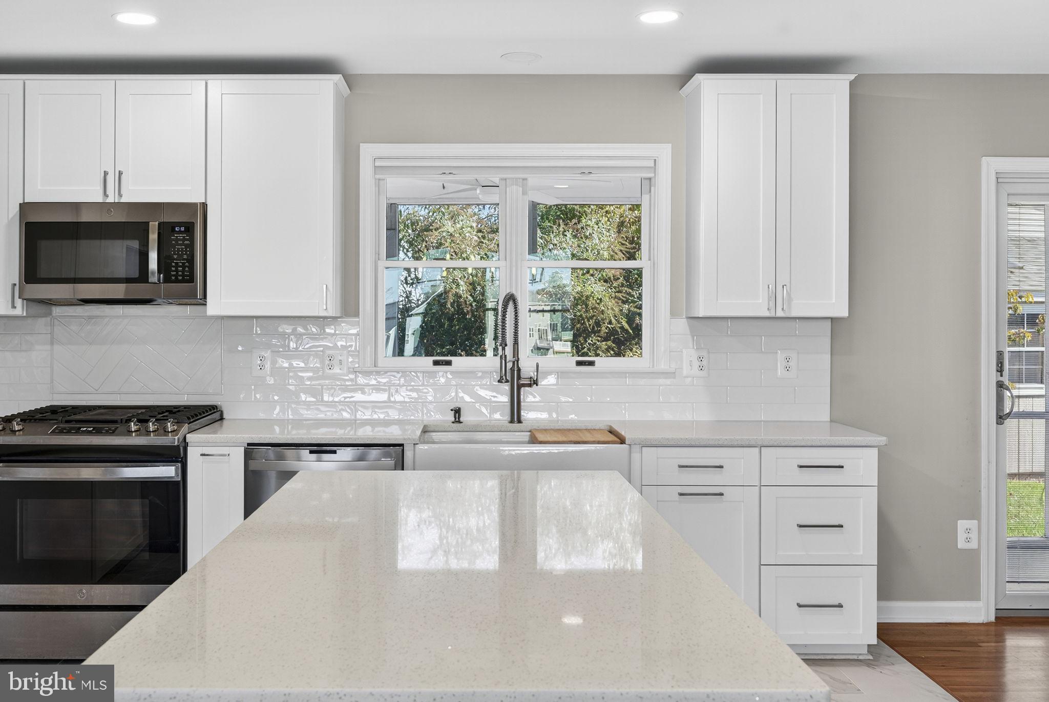 2140 6th Street Middletown, VA 22645 - Photo 12 of 62 a kitchen with granite countertop a stove sink and microwave