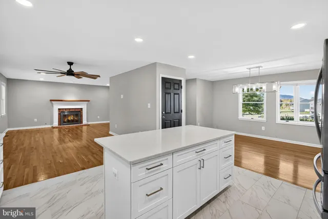 a view of empty room with wooden floor window and outdoor view