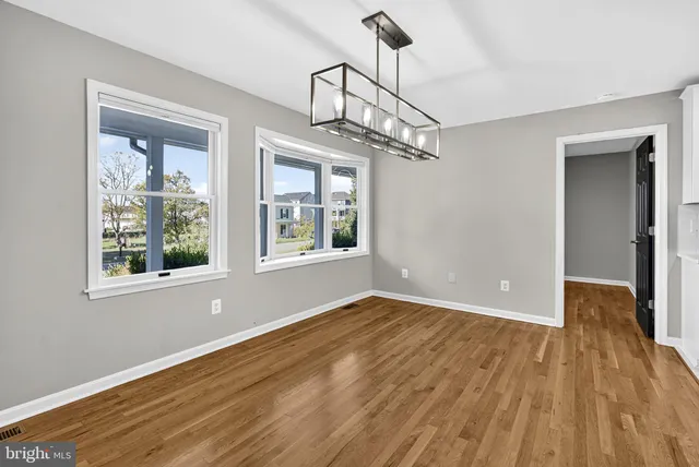 a view of kitchen with furniture and wooden floor