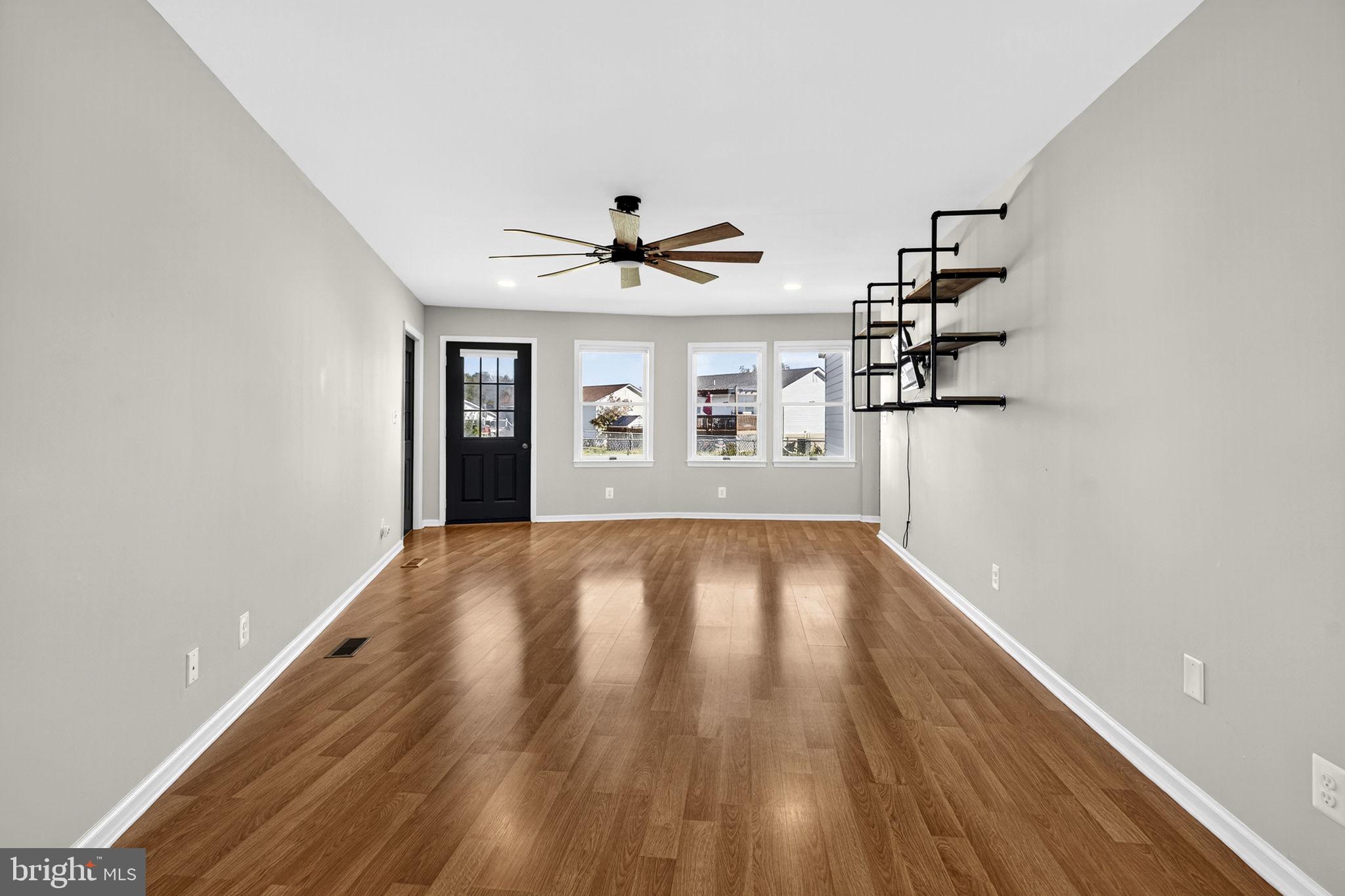 2140 6th Street Middletown, VA 22645 - Photo 19 of 62 wooden floor in an empty room with a window