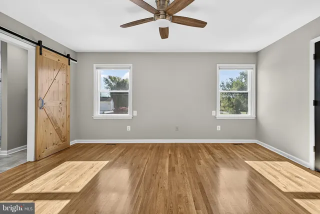 a view of a room with wooden floor