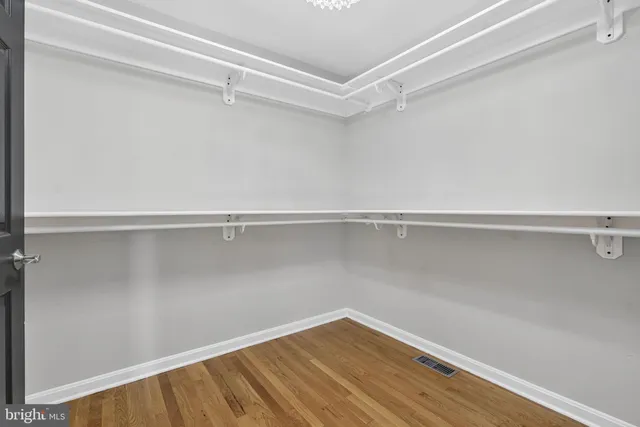 a bathroom with a granite countertop double vanity sink and mirror