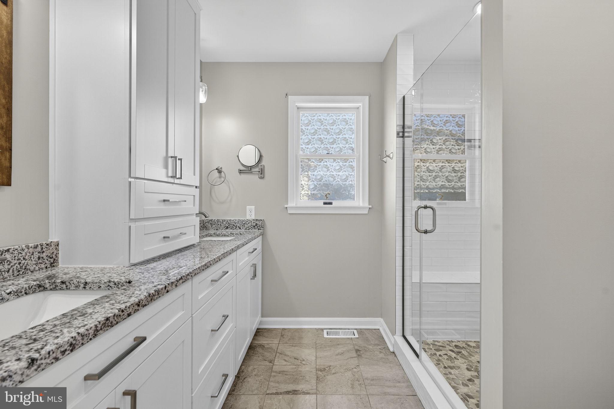 2140 6th Street Middletown, VA 22645 - Photo 28 of 62 a bathroom with a granite countertop sink and a mirror