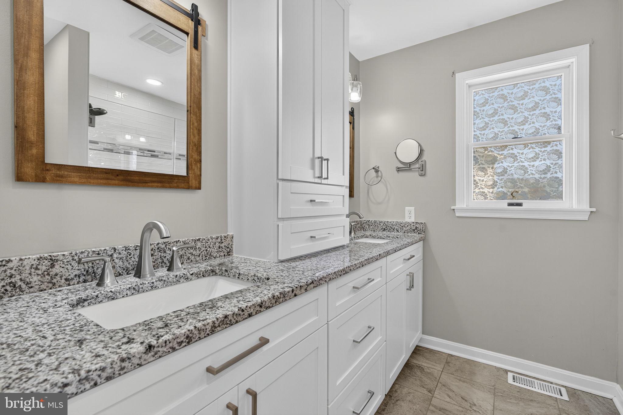 2140 6th Street Middletown, VA 22645 - Photo 29 of 62 a bathroom with a granite countertop double vanity sink and mirror
