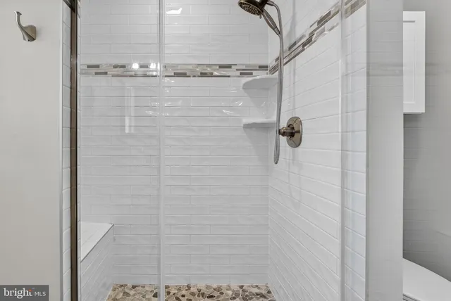 a bathroom with a glass shower door
