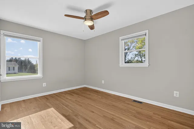 a view of a kitchen with a refrigerator a stove top oven and cabinets