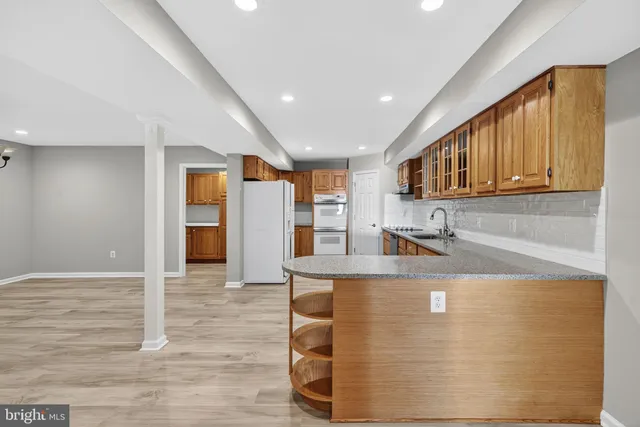 a bathroom with a granite countertop sink mirror and toilet