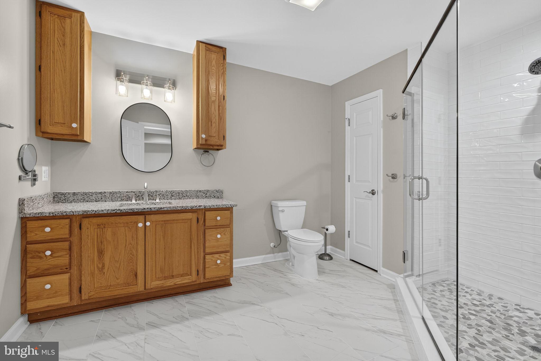 2140 6th Street Middletown, VA 22645 - Photo 52 of 62 a bathroom with a granite countertop sink mirror and toilet