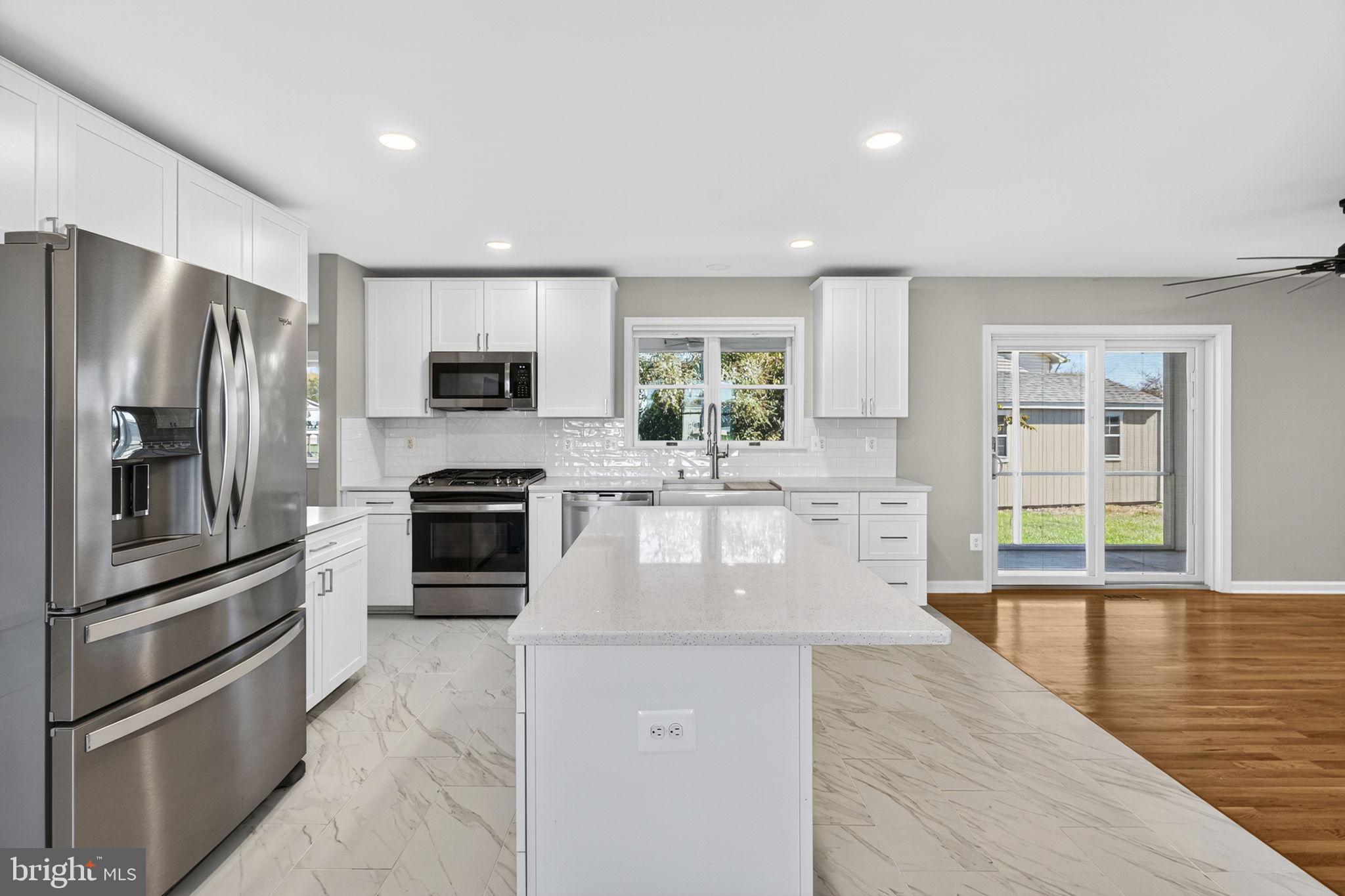2140 6th Street Middletown, VA 22645 - Photo 9 of 62 a large kitchen with granite countertop a large counter top stainless steel appliances and cabinets