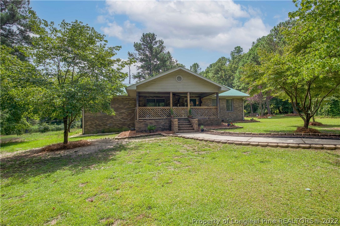 a front view of a house with a yard garage and outdoor seating