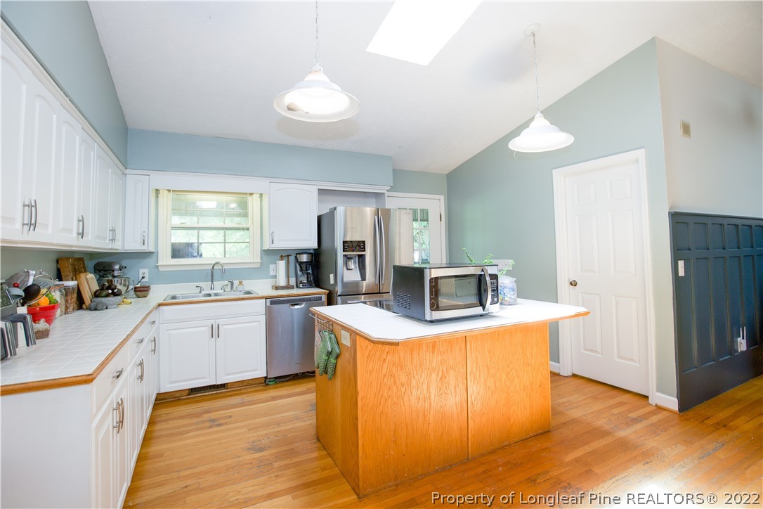 327 Scott Road Cameron, NC 28326 - Photo 12 of 48 a kitchen with a stove top oven and cabinets