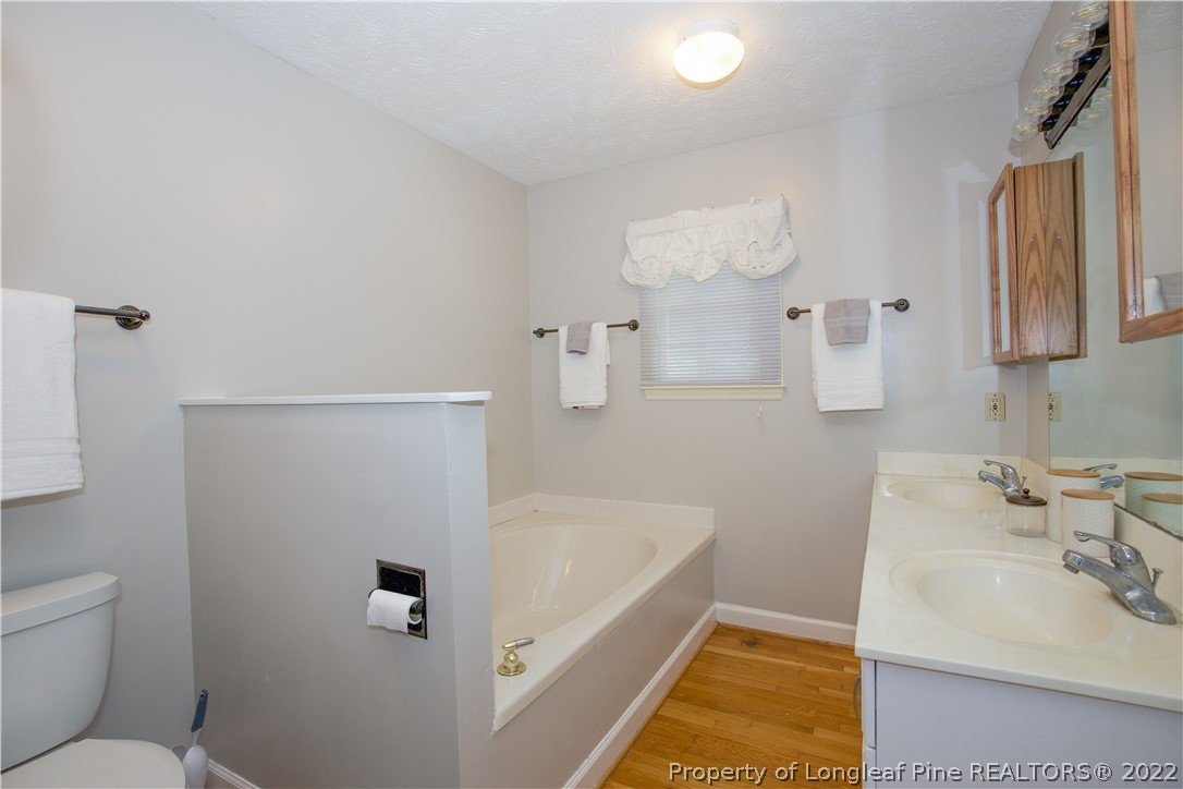 327 Scott Road Cameron, NC 28326 - Photo 22 of 48 a bathroom with a tub sink and mirror