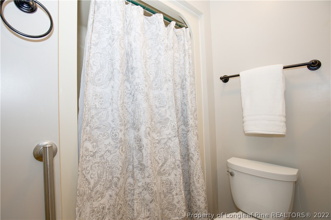 327 Scott Road Cameron, NC 28326 - Photo 24 of 48 a bathroom with a toilet and a shower curtain