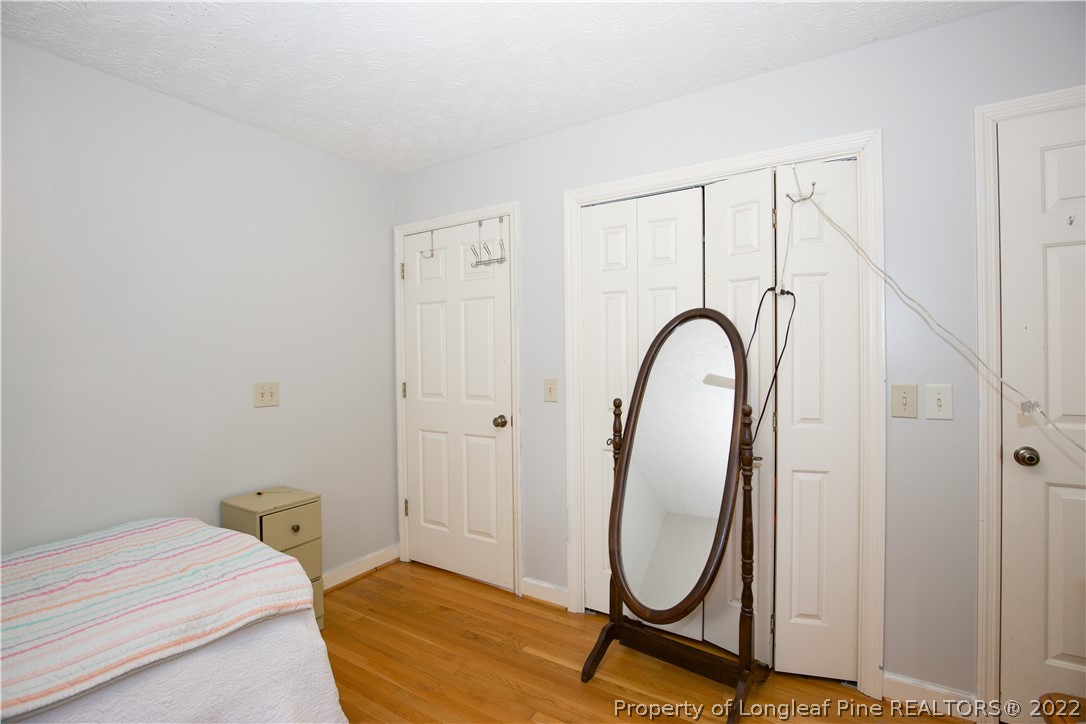 327 Scott Road Cameron, NC 28326 - Photo 29 of 48 a bedroom with a bed a mirror with the shower curtain