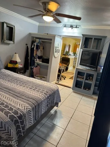 a bed room with a bed and a television