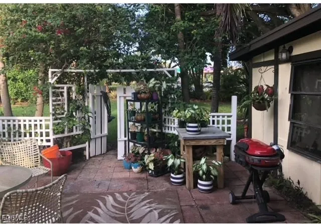 a view of two chairs and tables in the patio