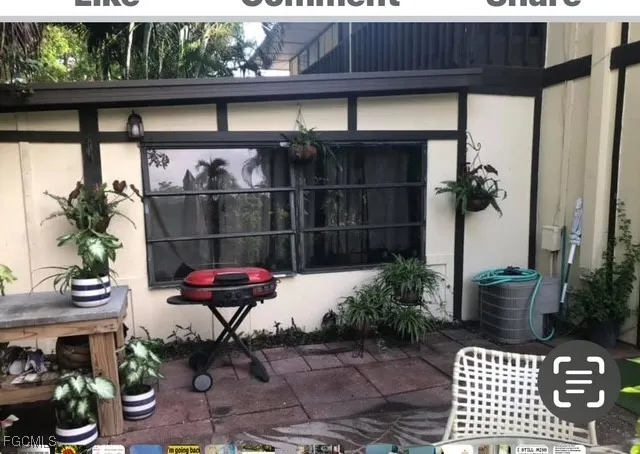 a view of a chair and table in backyard