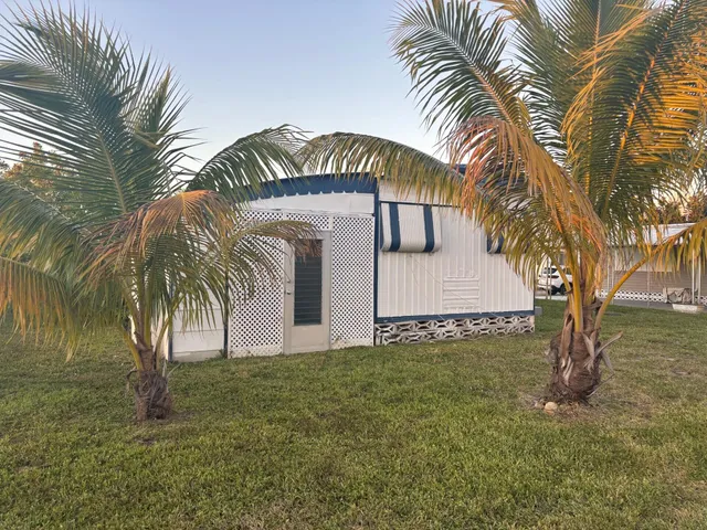 a view of a palm trees in front of a house