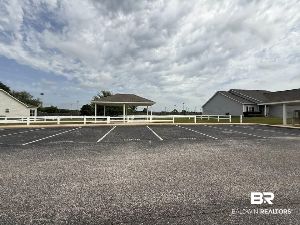 2651 South Juniper Street, Unit 401 Foley, AL 36535 - Photo 7 of 27 Uncovered parking lot featuring fence