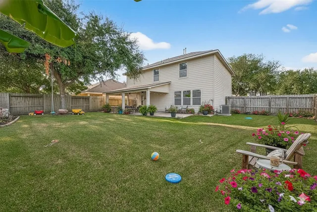 a backyard of a house with table and chairs