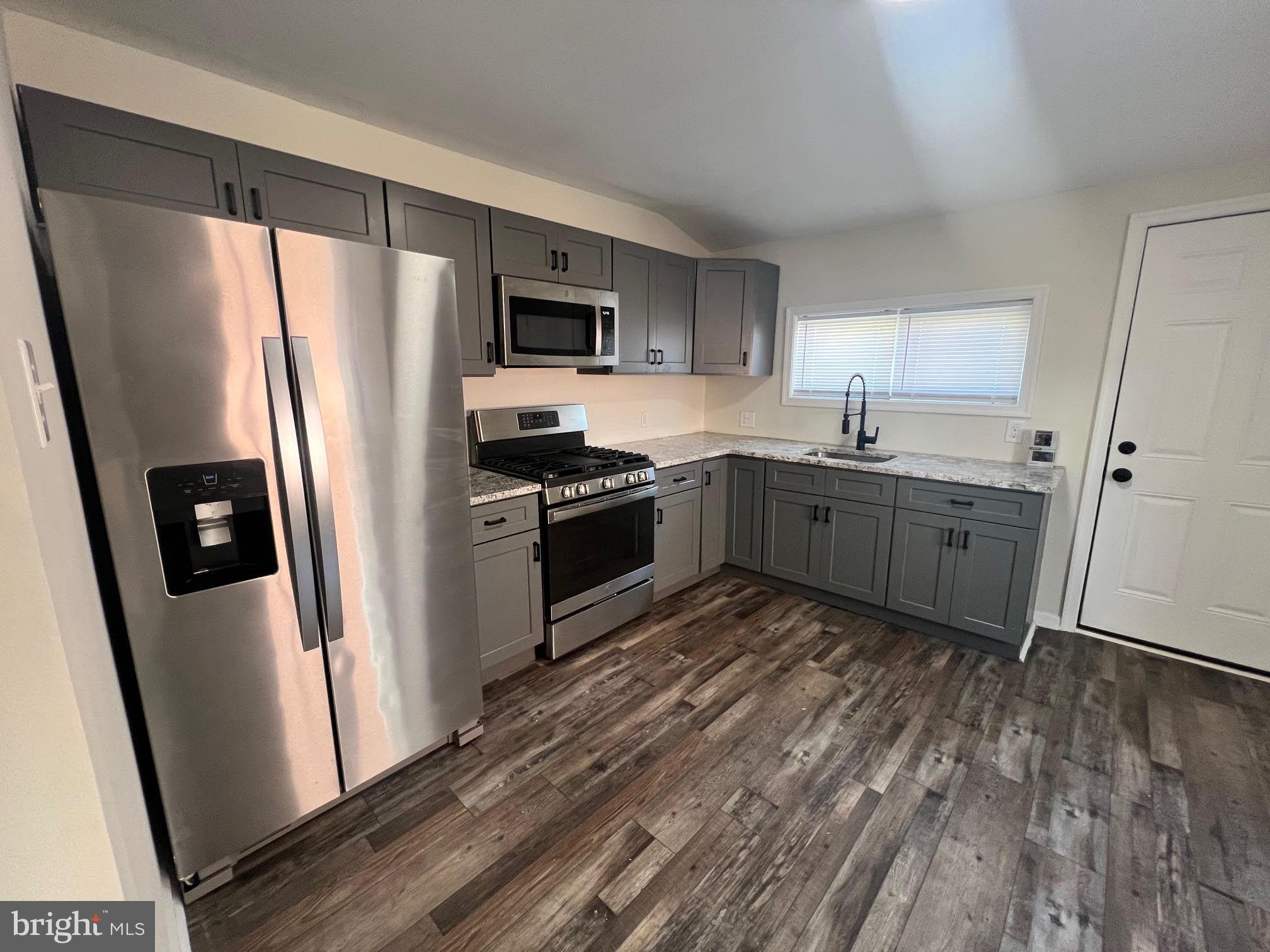 107 Church Street, Unit B Glassboro, NJ 08028 - Photo 3 of 9 a kitchen with stainless steel appliances a refrigerator sink and microwave