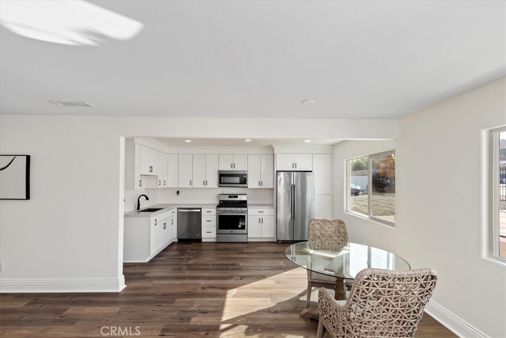 19594 Temescal Canyon Road Corona, CA 92881 - Photo 34 of 50 a living room with stainless steel appliances kitchen island granite countertop furniture and a rug