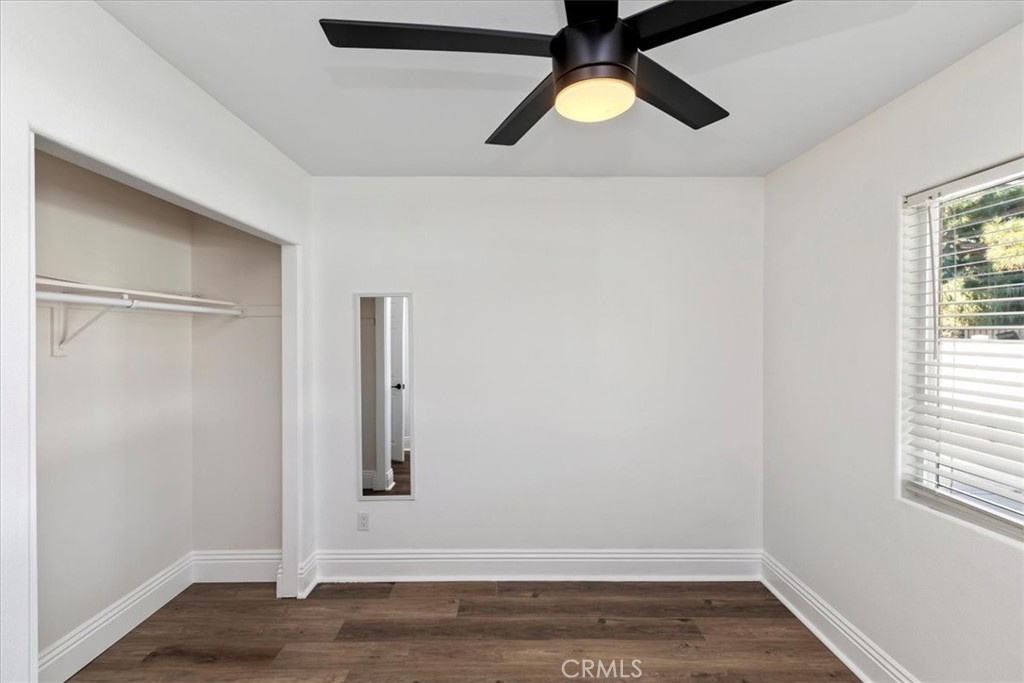 19594 Temescal Canyon Road Corona, CA 92881 - Photo 42 of 50 an empty room with wooden floor cabinet and windows