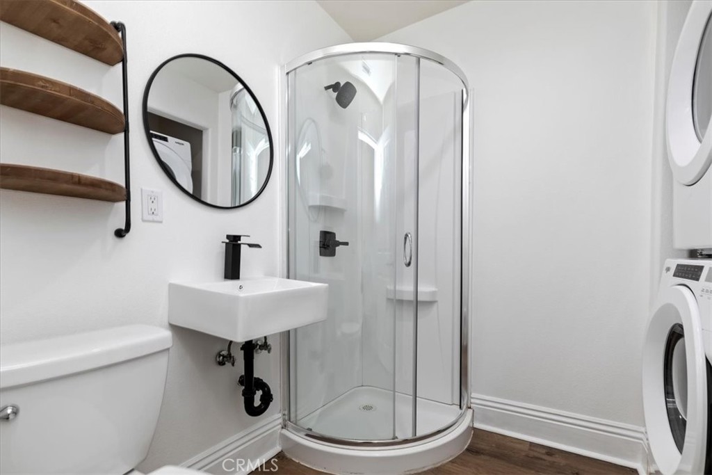 19594 Temescal Canyon Road Corona, CA 92881 - Photo 45 of 50 a bathroom with a sink a mirror a toilet and a shower