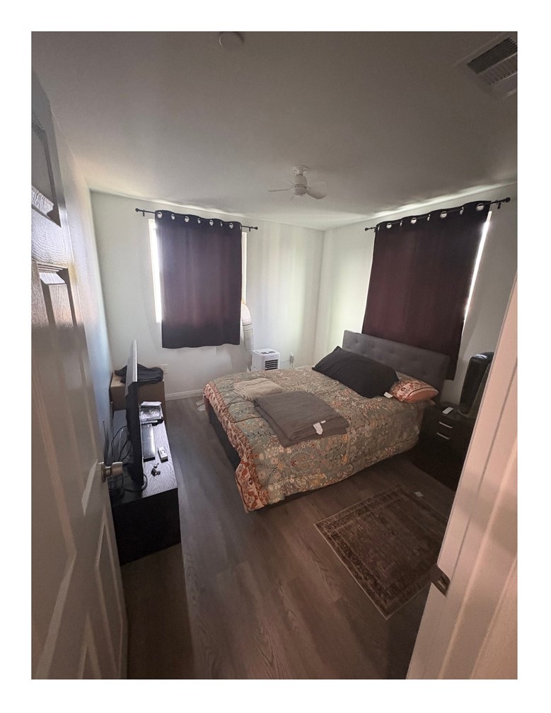 720 West Cherry Street Compton, CA 90222 - Photo 32 of 32 a bedroom with a bed and wooden floor