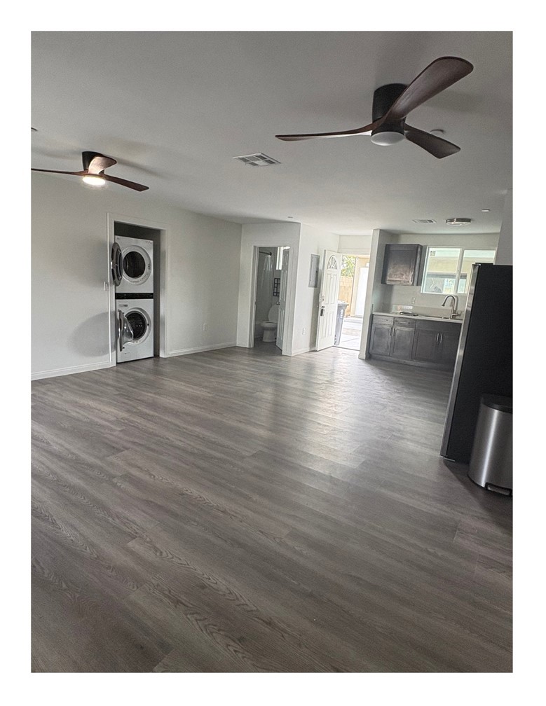 720 West Cherry Street Compton, CA 90222 - Photo 5 of 32 a view of a hallway with wooden floor and a ceiling fan