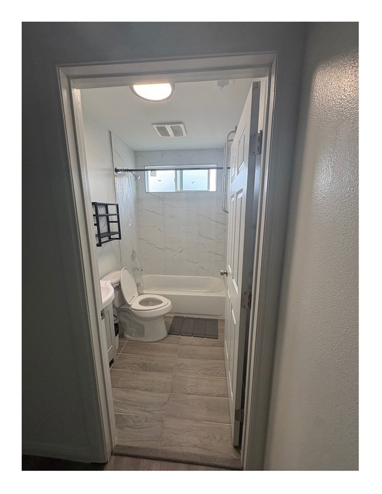 720 West Cherry Street Compton, CA 90222 - Photo 8 of 32 a bathroom with a toilet and a mirror