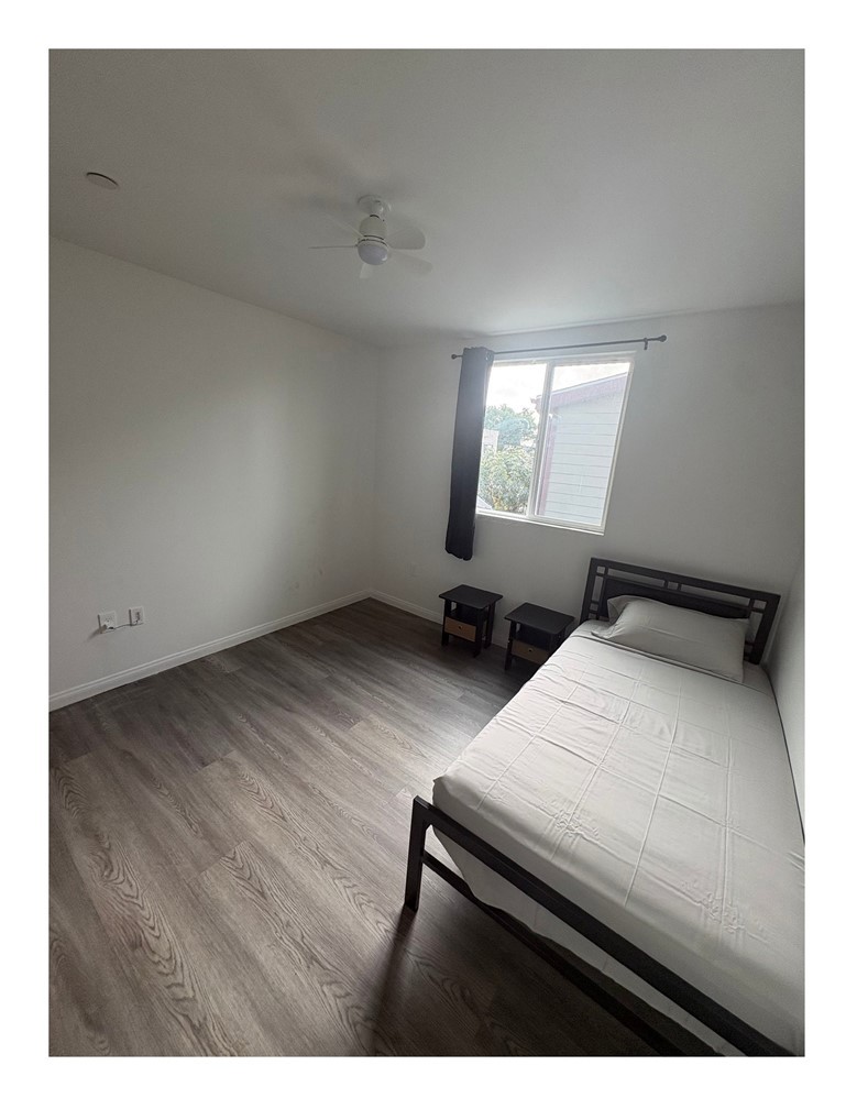 720 West Cherry Street Compton, CA 90222 - Photo 10 of 32 a room with a bed and wooden floor