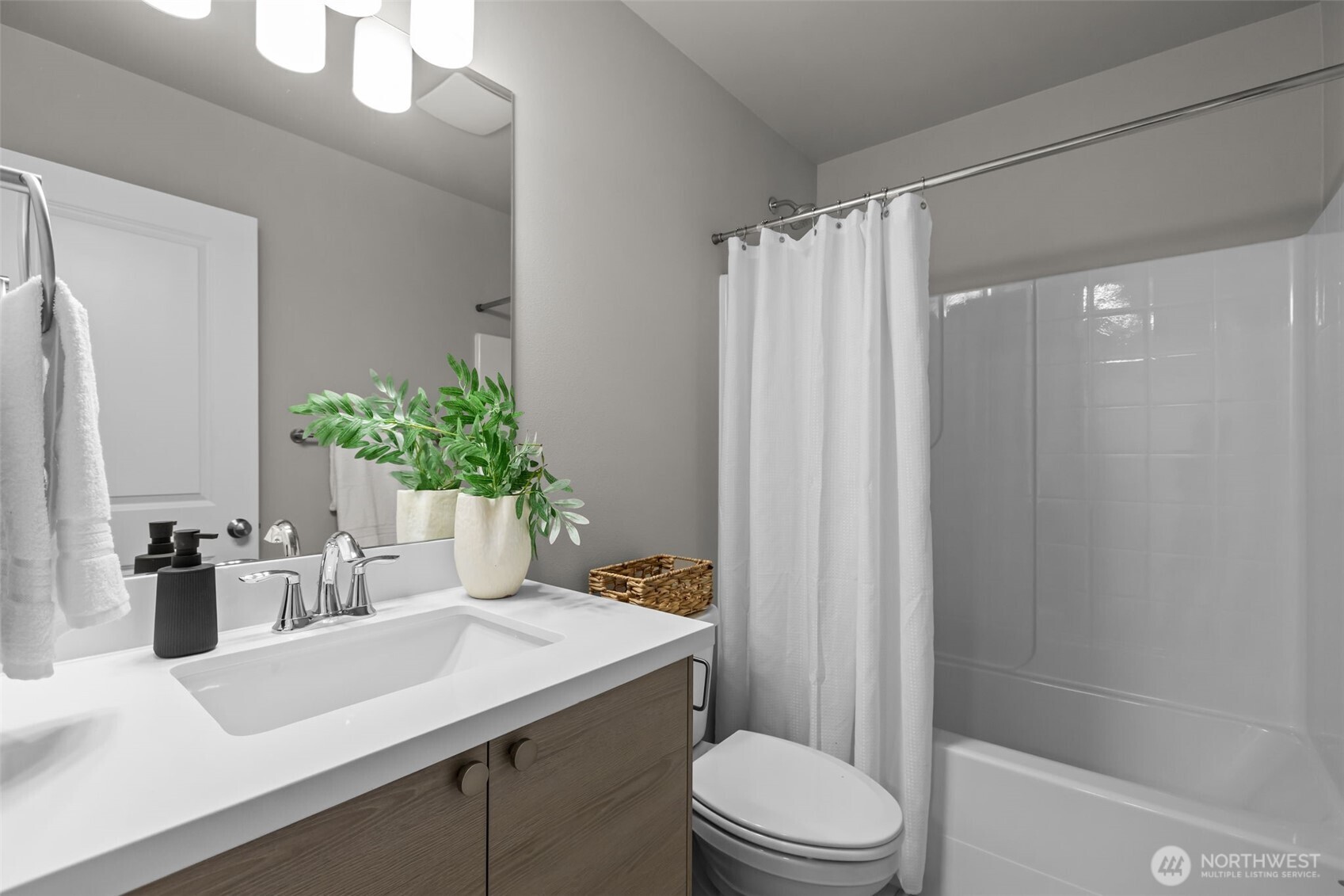 110 169th Place Southwest, Unit A Bothell, WA 98012 - Photo 19 of 29 a bathroom with a sink a toilet a mirror and shower