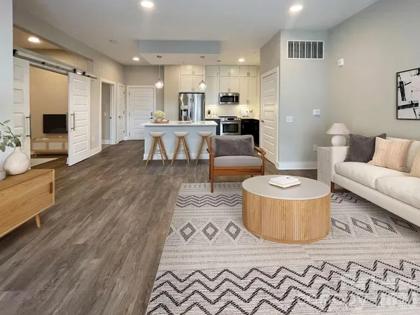 a kitchen with a table chairs refrigerator and microwave