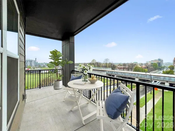 a living room with furniture and a dining table with kitchen view