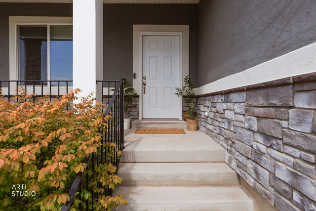 1654 South 730 West Provo, UT 84601 - Photo 2 of 33 Front entry featuring stone veneer wainscoting, a white paneled door, and a concrete porch with steps