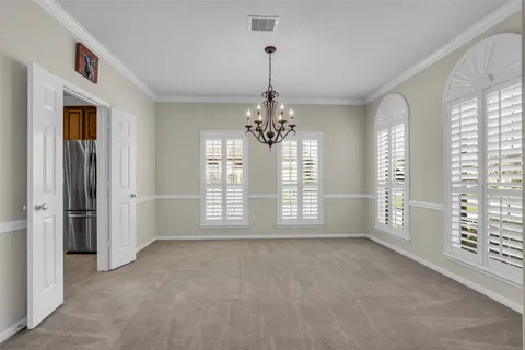 a view of an empty room with a window and bathroom