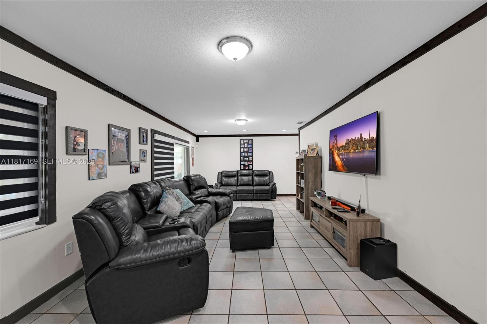 30930 Southwest 190th Avenue Homestead, FL 33030 - Photo 13 of 36 a living room with furniture and a flat screen tv