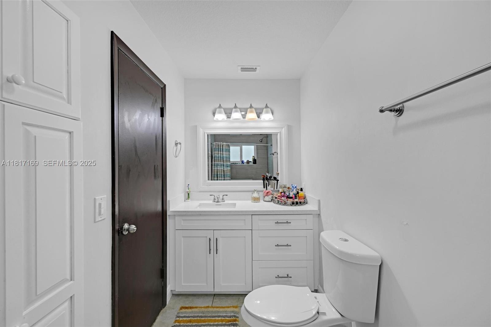 30930 Southwest 190th Avenue Homestead, FL 33030 - Photo 17 of 36 a bathroom with a toilet sink and mirror