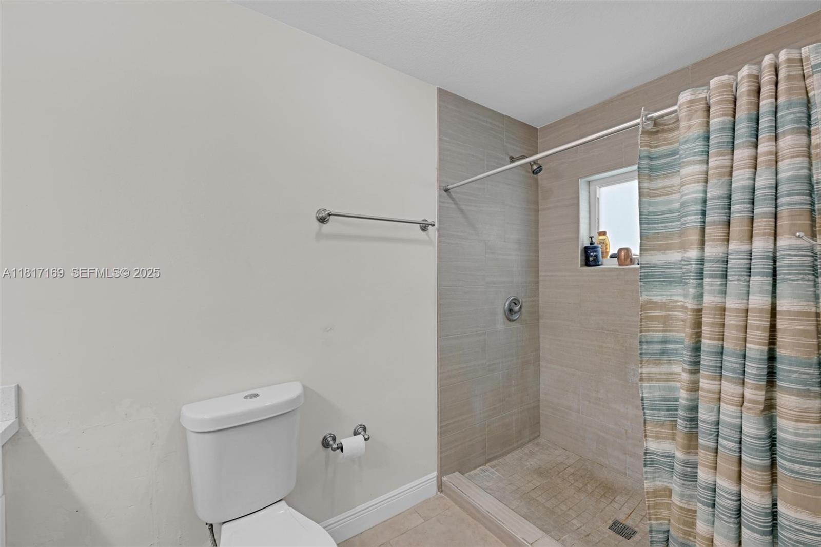 30930 Southwest 190th Avenue Homestead, FL 33030 - Photo 18 of 36 a bathroom with a shower and toilet