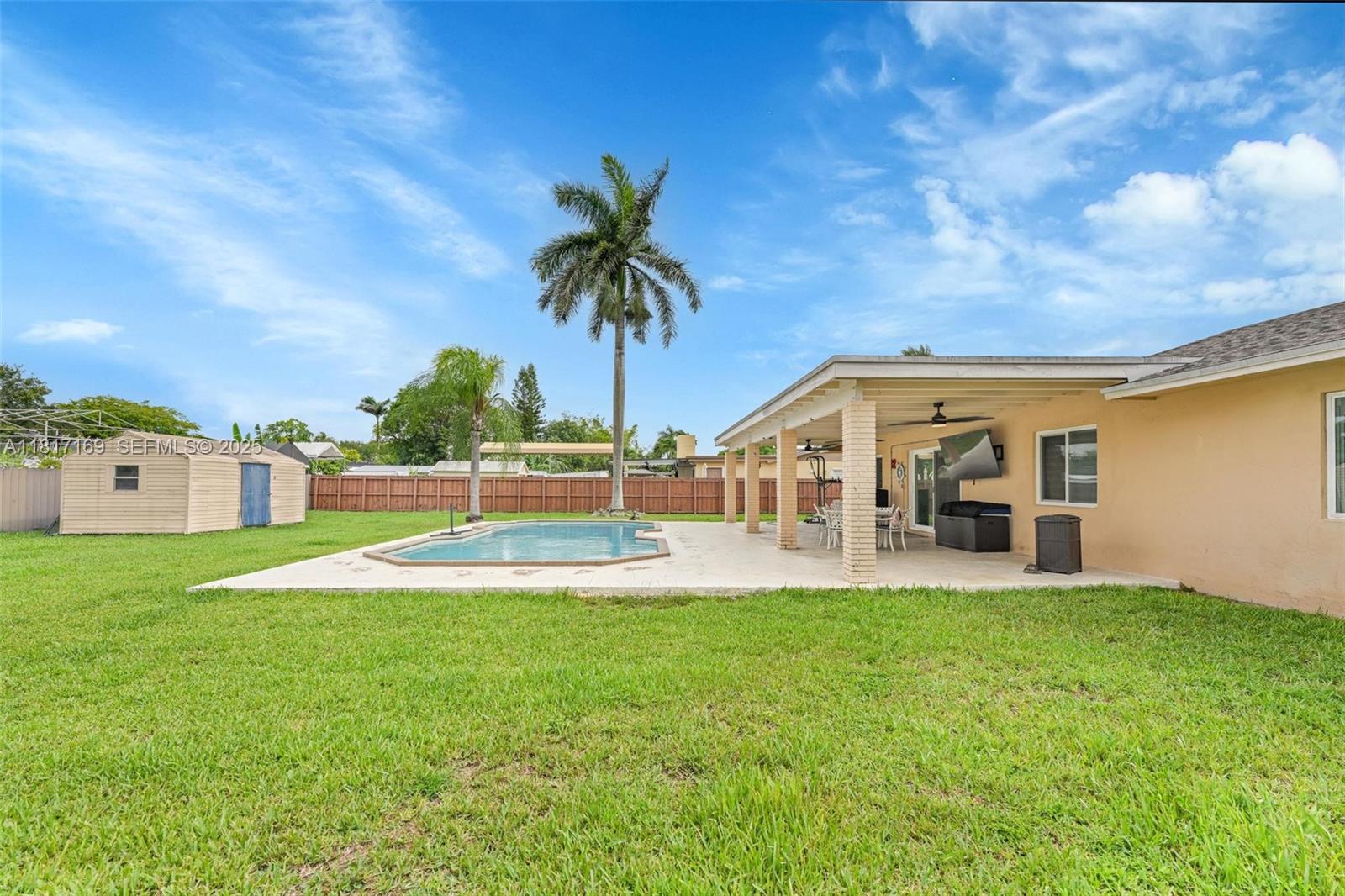 30930 Southwest 190th Avenue Homestead, FL 33030 - Photo 23 of 36 a view of a house with a big yard and potted plants