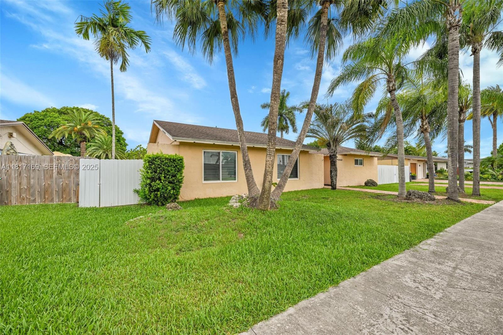 30930 Southwest 190th Avenue Homestead, FL 33030 - Photo 32 of 36 a view of a house with a palm trees